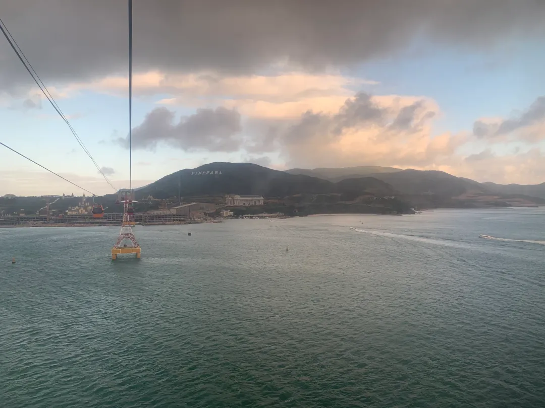 The view from a cable-car cabin towards Hòn Tre, VINPEARL lettering on the hillside